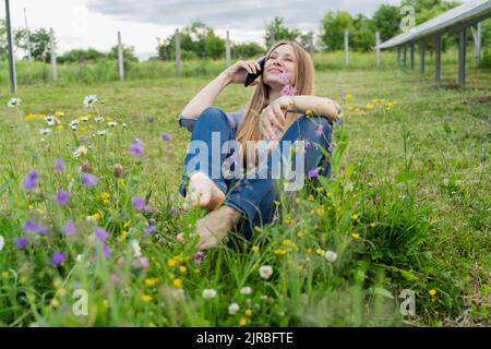 Happy engineer talking on smart phone at field Stock Photo