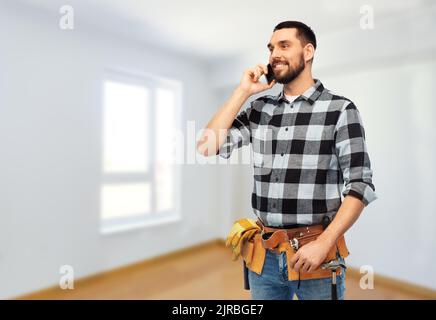builder in helmet calling on smartphone Stock Photo