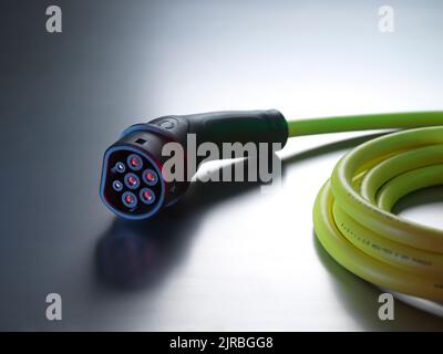 Electric vehicle charging cable on table Stock Photo