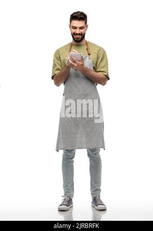 smiling waiter in apron taking notes to notepad Stock Photo