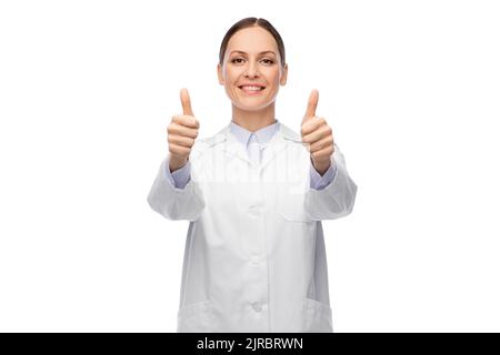 smiling female doctor showing thumbs up Stock Photo