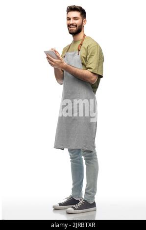 smiling waiter in apron taking notes to notepad Stock Photo