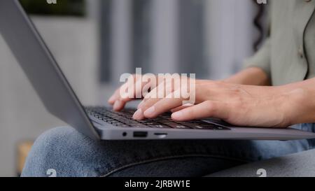 Closeup female hands unrecognizable businesswoman professional user worker writer freelancer using computer app typing laptop notebook keyboard Stock Photo