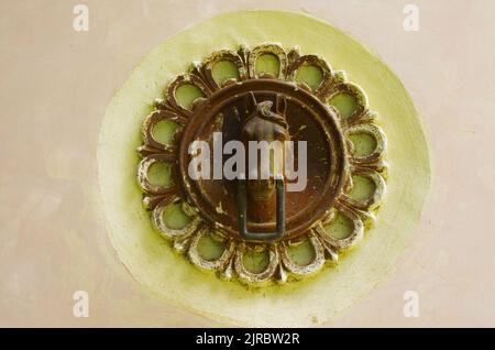 Ancient iron ornament to tie horses or draft animals to the walls of buildings Stock Photo