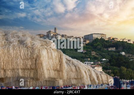 umbrellas lined up on the beach with a view of the city of vasto abruzzo Stock Photo