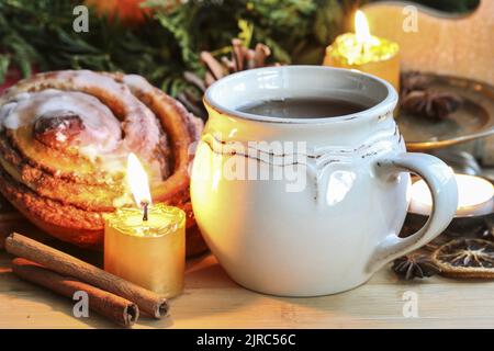 A ceramic mug with tea among traditional Christmas decorations. Festive time Stock Photo