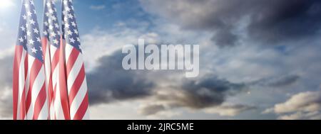 USA flags on poles, cloudy sky background, banner. National America Holiday template, copy space. 3d render Stock Photo