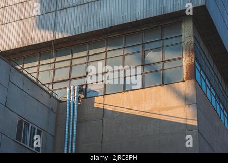 Beautiful sunlight on the windows of a factory building. Stock Photo