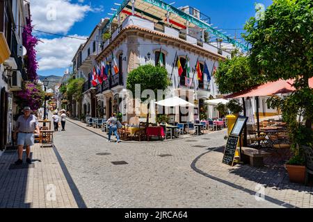 The beautiful streets with restaurants in Malaga, Spain, in sunny weather Stock Photo