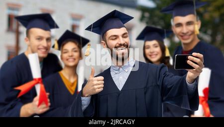 graduate students with smartphone taking selfie Stock Photo