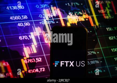 KONSKIE, POLAND - August 10, 2022: Smartphone displaying logo of FTX US cryptocurrency exchange on stock exchange diagram background Stock Photo