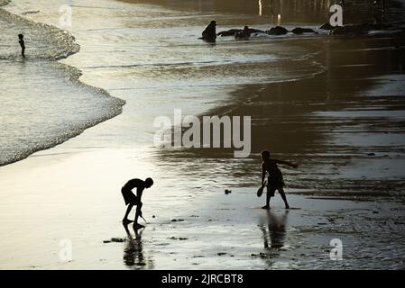 Salvador, Bahia, Brazil - November 01, 2021: Two young men playing beach soccer at Rio Vermelho beach in Salvador, Bahia in the late afternoon. Stock Photo