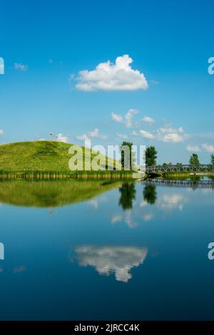 A calm lake with reflections at the Winkler Bible Camp, Winkler, Manitoba, Canada. Stock Photo