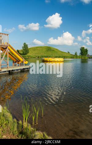 A calm lake with reflections at the Winkler Bible Camp, Winkler, Manitoba, Canada. Stock Photo