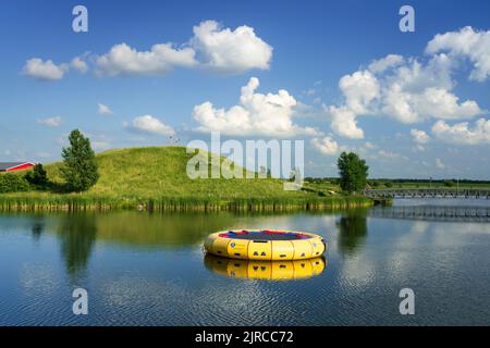 A calm lake with reflections at the Winkler Bible Camp, Winkler, Manitoba, Canada. Stock Photo