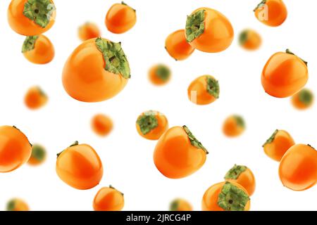 Falling persimmon isolated on white background, selective focus Stock Photo