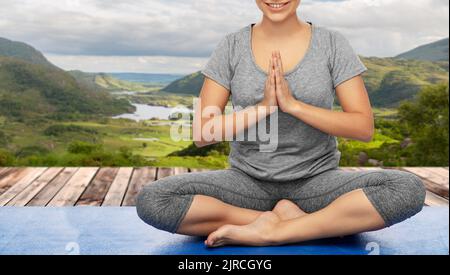 woman doing yoga over Killarney National Park Stock Photo