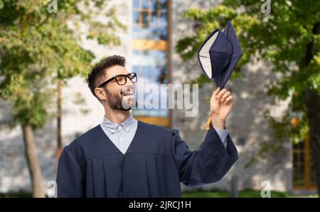 graduate student in bachelor gown with mortarboard Stock Photo