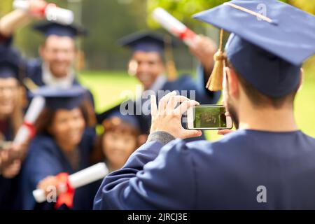 graduate students taking photo with smartphone Stock Photo