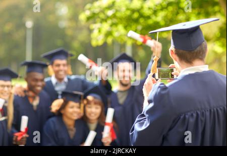 graduate students taking photo with smartphone Stock Photo