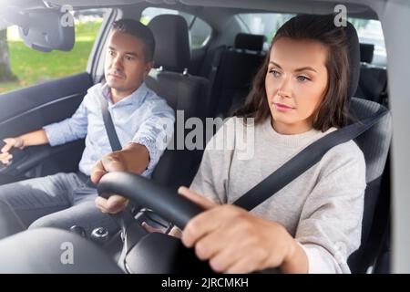 car driving school instructor teaching woman Stock Photo