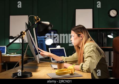 Transgender programmer working in server room Stock Photo