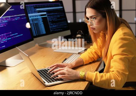Transgender programmer working in server room Stock Photo