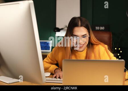 Transgender programmer working in server room Stock Photo