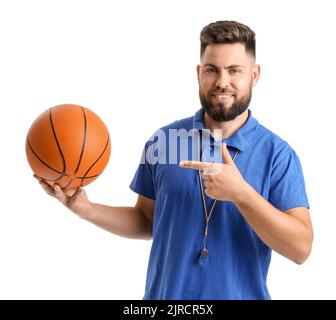 Handsome PE teacher pointing at ball on white background Stock Photo