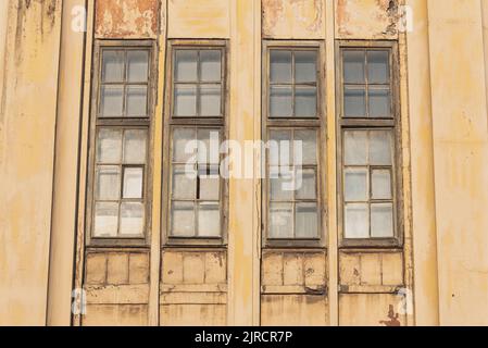 Narrow vertical windows of a century-old factory. Closeup, historic industrial architecture Stock Photo