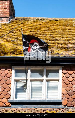 Pirate flag outside a house Stock Photo