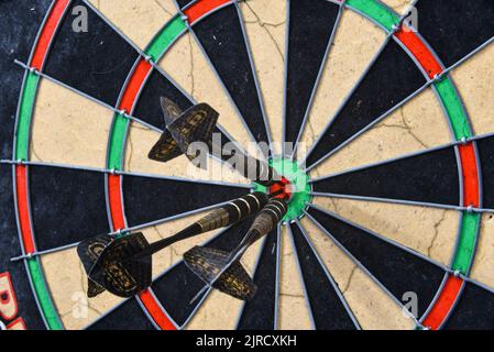 Den Helder, Netherlands. August 2022. The three darts in the bullseye of the dartboard. High quality photo Stock Photo