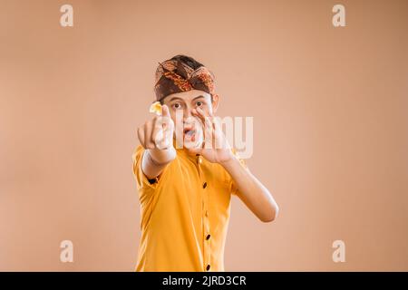 balinese male making announcement over isolated background Stock Photo