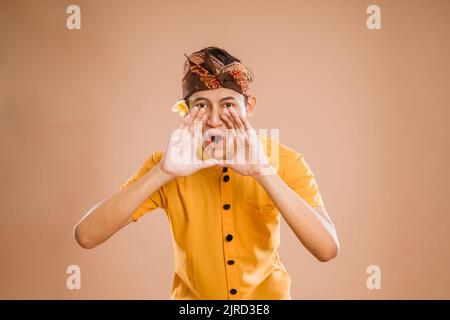 balinese male making announcement over isolated background Stock Photo