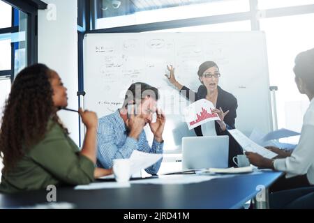 For the last time, I dont need anger management. a stressed businesswoman losing her temper during a meeting with her colleagues in the boardroom. Stock Photo
