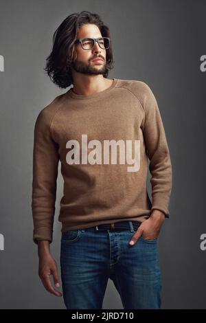 The future is not too far away. Studio shot of a handsome young man posing against a gray background. Stock Photo