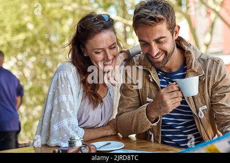 Theres so much to see in this city. a happy tourist couple planning their day while having coffee at a sidewalk cafe. Stock Photo