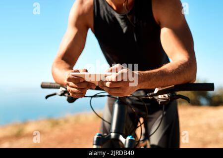 If youre passionate about something, why not write about it. an unrecognizable man using his cellphone while out for a ride on his mountain bike. Stock Photo