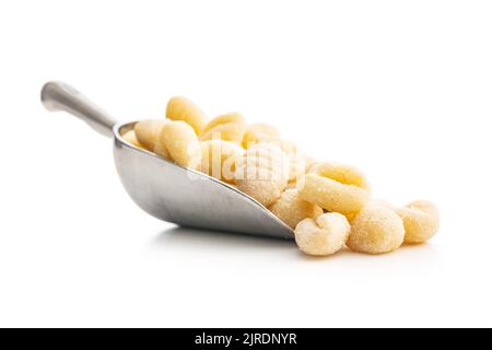 Uncooked potato gnocchi in scoop isolated on a white background. Stock Photo