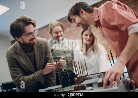 Architect team with blueprints and layout design project at office bureau Stock Photo