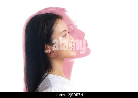Multiple exposure portrait of asian woman with positive smile and serious sad facial expression. Mental health, depression contemplation and emotions overstressed bipolar Stock Photo