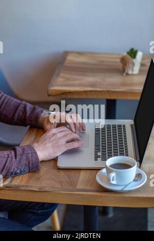 Close up of mans hands typing on laptop Stock Photo