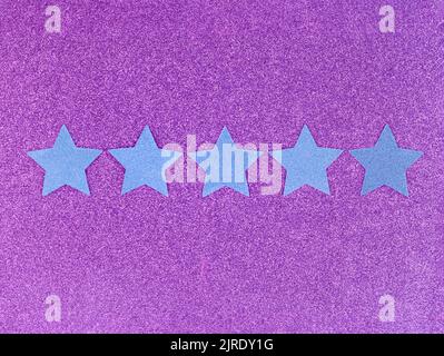 Five Star Rating on pink background. Blue glitter stars. ranking concept Stock Photo
