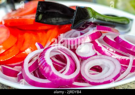 A plate of sliced red onion and tomato. Stock Photo