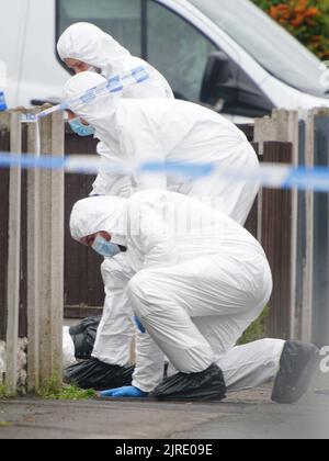 Forensics officers at the scene of an incident at a property in Kingsheath Avenue, Knotty Ash, Liverpool, where nine-year-old Olivia Pratt-Korbel was fatally shot on Monday night. The people of Liverpool have been urged to turn in the masked gunman who killed Olivia as he chased his intended target into her home. Picture date: Wednesday August 24, 2022. Stock Photo