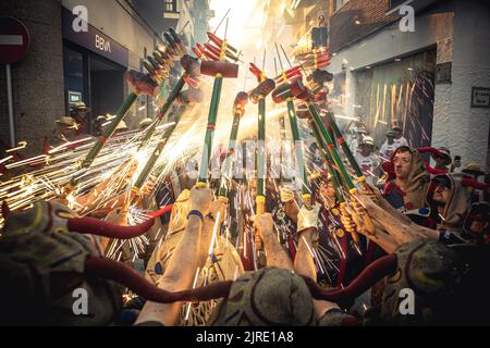 Sitges, Spain. 24th Aug, 2022. 'Diables de Sitges - Colla vella' gather to enlighten their stick mounted fire crackers during the traditional morning 'correfoc' at the 'Festa Major de Sitges' Credit: Matthias Oesterle/Alamy Live News Stock Photo