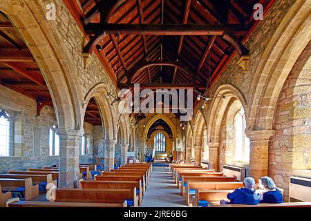 Newbiggin by the sea Northumberland beautiful seaside village with 13th century St Batholomews church looking down the nave towards the East window Stock Photo