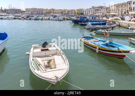 boats moored around the port city of trani on the adriatic sea in puglia italy Stock Photo