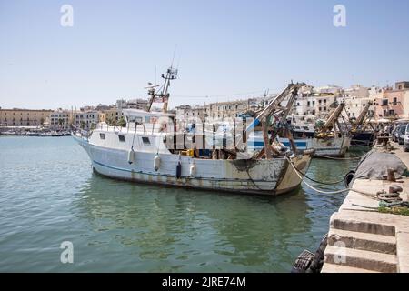 fishing boats moored around the port city of trani on the adriatic sea in puglia italy Stock Photo