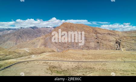 large mountain canyons in Himalayas of Spiti Valley in North India during sunny summer day, aerial Stock Photo